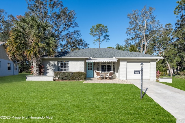 single story home featuring a front yard and a garage