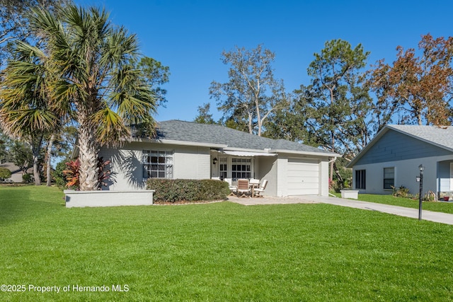 ranch-style home featuring a garage and a front lawn