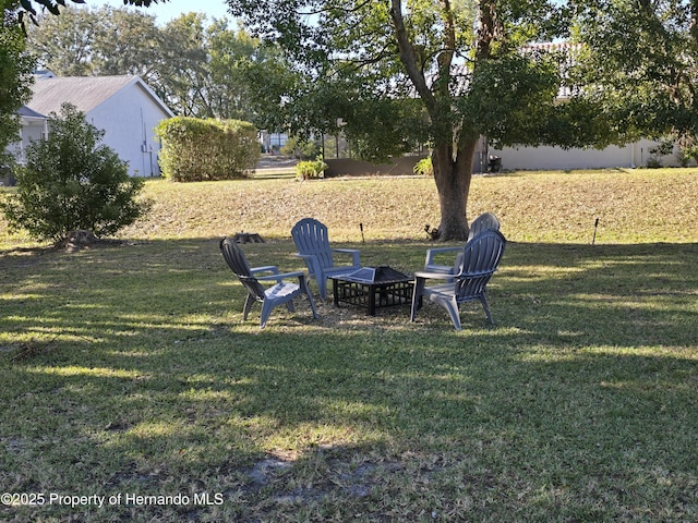 view of yard with a fire pit