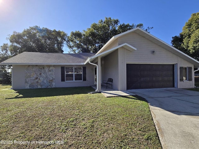 single story home featuring a garage and a front lawn