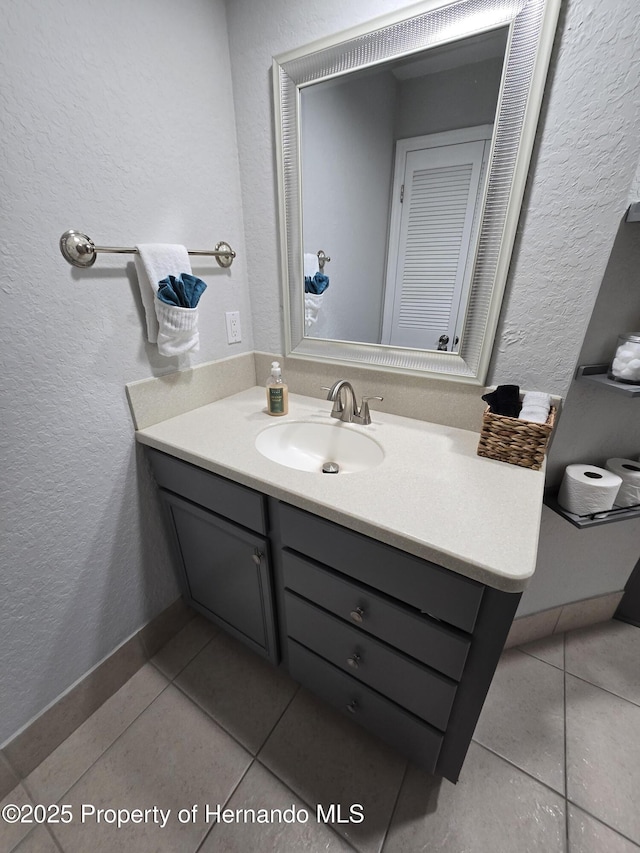 bathroom with tile patterned flooring and vanity