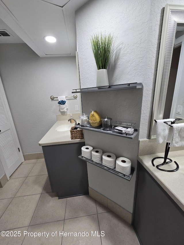 bathroom with tile patterned flooring and vanity