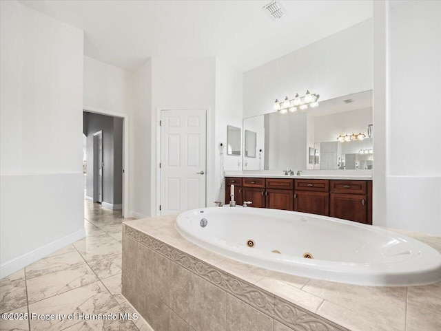 full bathroom with baseboards, visible vents, a whirlpool tub, marble finish floor, and vanity