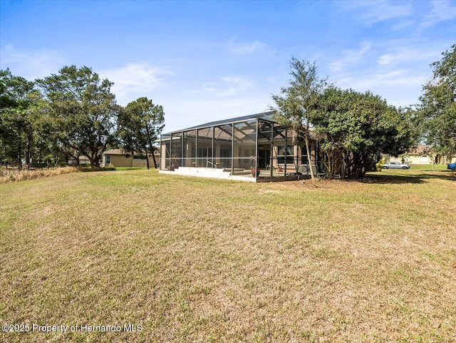 view of yard with glass enclosure