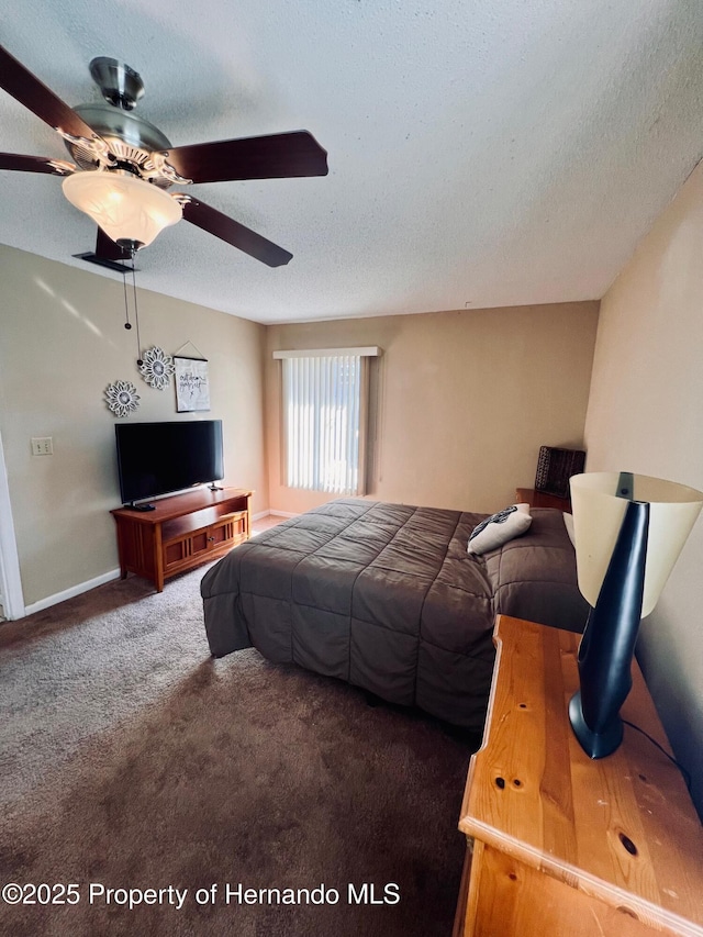 bedroom featuring carpet flooring, a textured ceiling, and ceiling fan