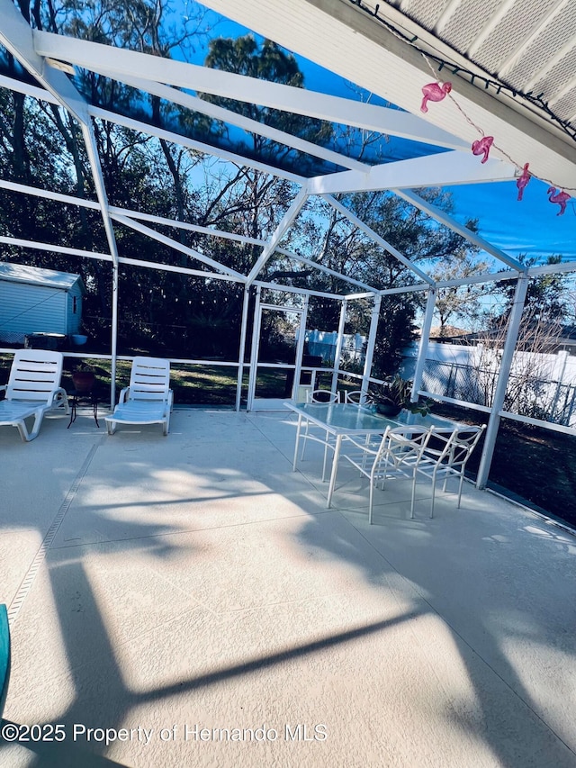 view of patio / terrace with a lanai