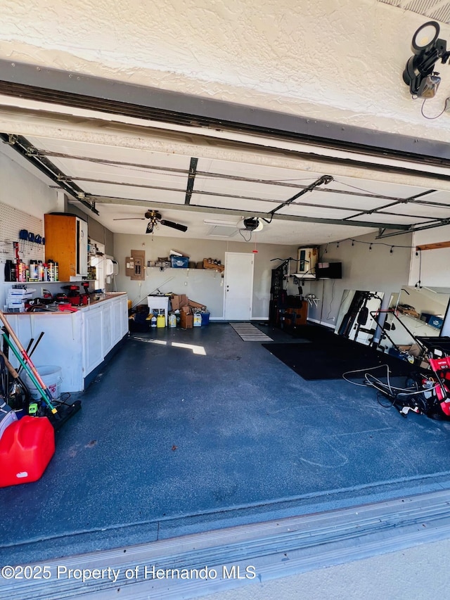 garage featuring ceiling fan and a garage door opener