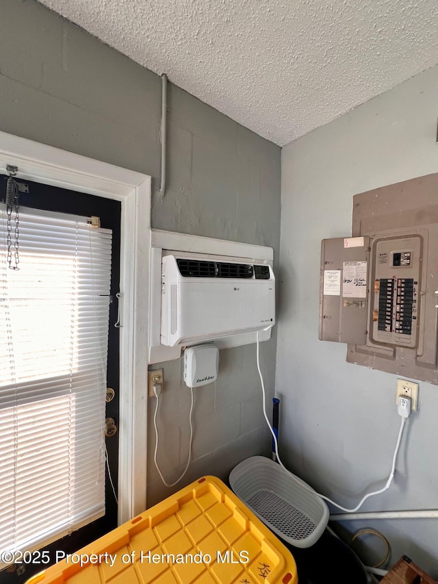 utilities featuring a wall mounted AC and electric panel