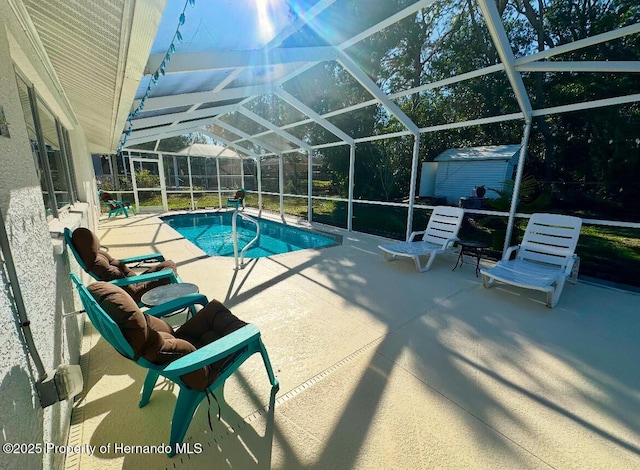 view of pool featuring a storage unit, a lanai, and a patio