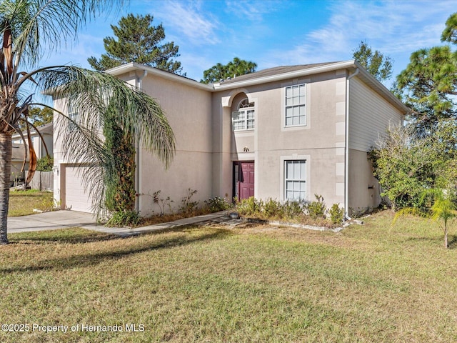 view of front of property with a garage and a front lawn