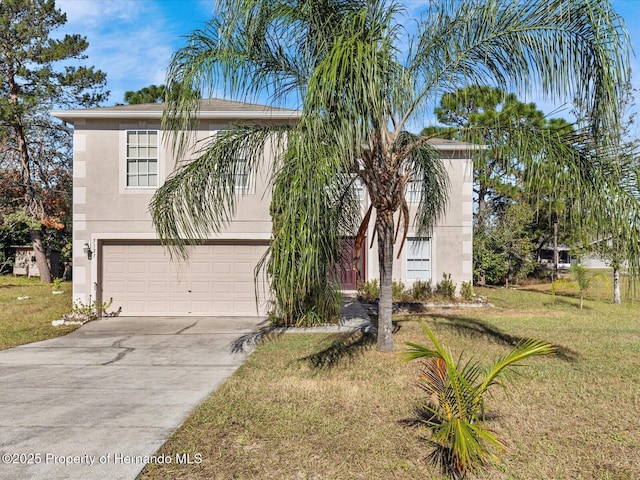 view of front of property with a front yard and a garage