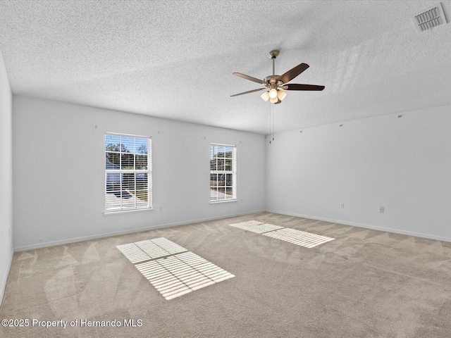 carpeted empty room featuring a textured ceiling and ceiling fan