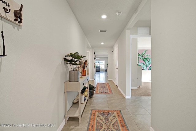 hall featuring light tile patterned flooring