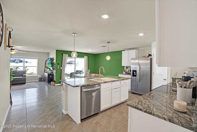 kitchen with white cabinetry, sink, an island with sink, and stainless steel appliances