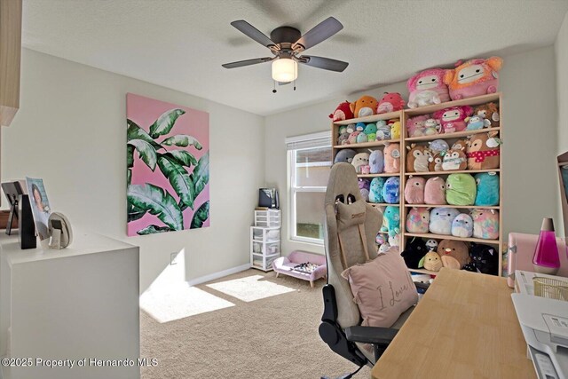 office area featuring ceiling fan, carpet floors, and a textured ceiling