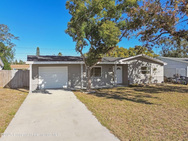 ranch-style home with a front yard and a garage