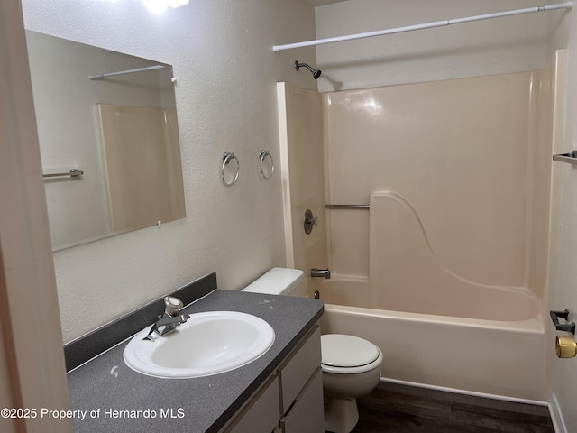 full bathroom featuring hardwood / wood-style flooring, vanity, toilet, and shower / bath combination