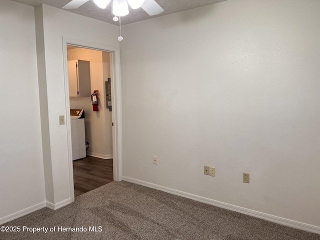 carpeted spare room featuring ceiling fan and washer / dryer