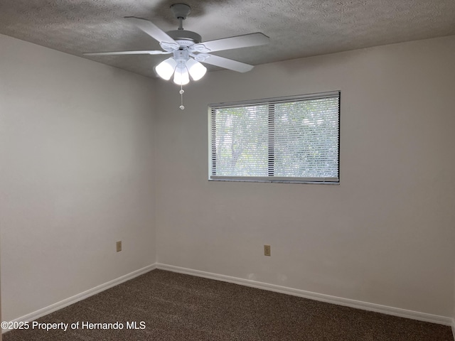 carpeted spare room featuring a textured ceiling and ceiling fan