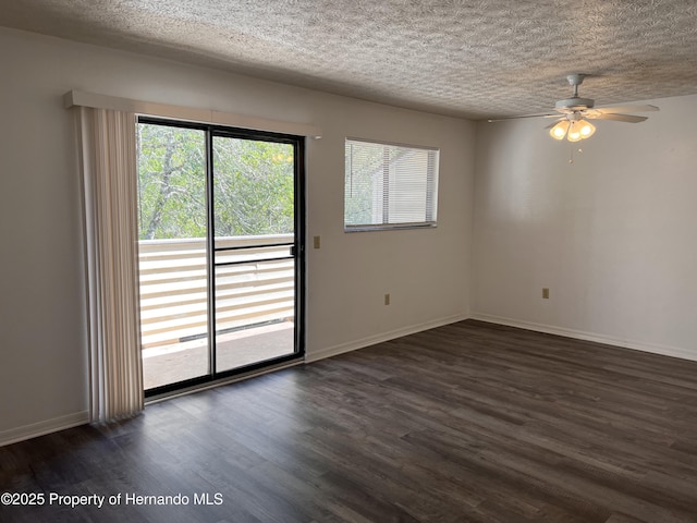 spare room featuring plenty of natural light and dark hardwood / wood-style flooring