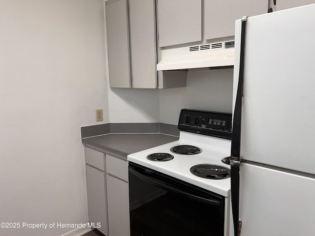 kitchen with range with electric cooktop and white fridge