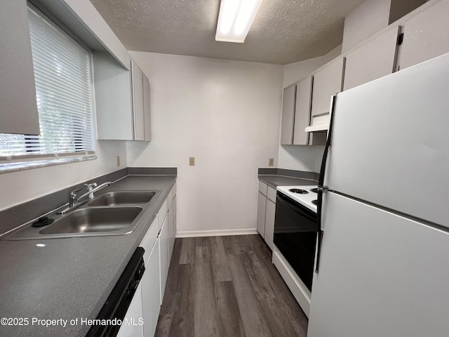 kitchen with dark wood-type flooring, sink, a textured ceiling, white appliances, and white cabinets