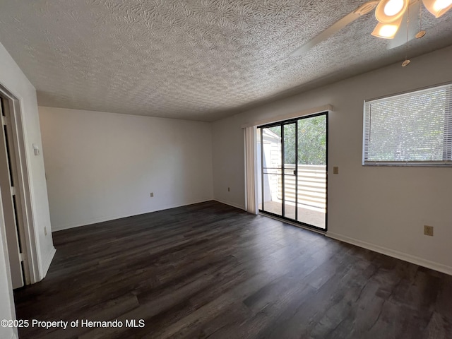 empty room featuring ceiling fan, dark hardwood / wood-style flooring, and a textured ceiling