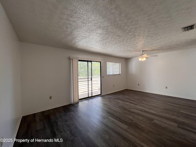 spare room with ceiling fan, dark hardwood / wood-style floors, and a textured ceiling