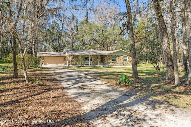 single story home featuring a porch and a garage