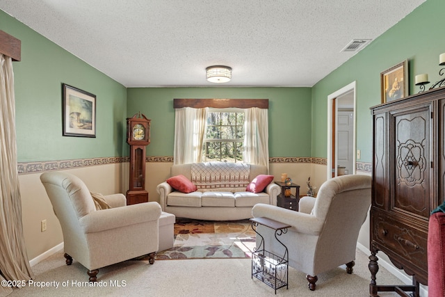 carpeted living room featuring a textured ceiling