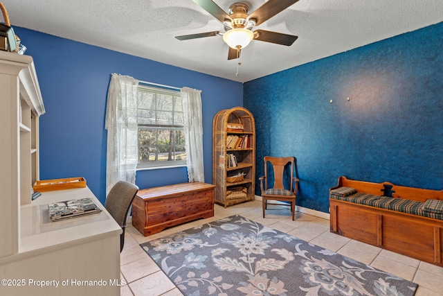 tiled bedroom with a textured ceiling and ceiling fan