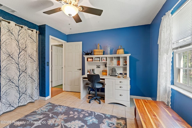 home office with ceiling fan and light tile patterned floors