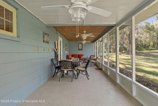 sunroom / solarium with a healthy amount of sunlight and wood ceiling