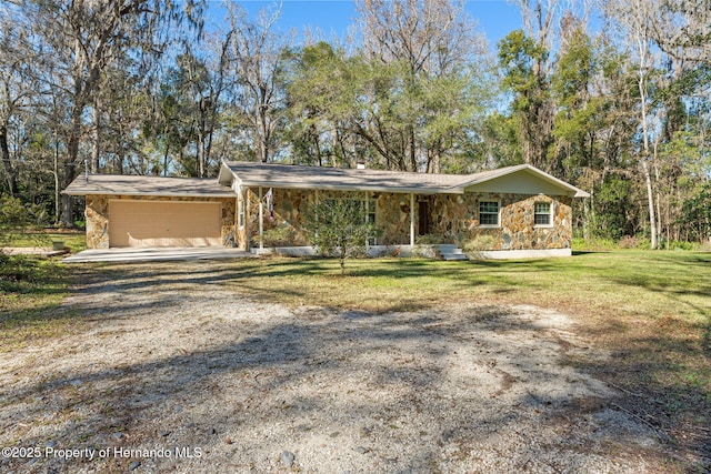 ranch-style home featuring a garage and a front lawn