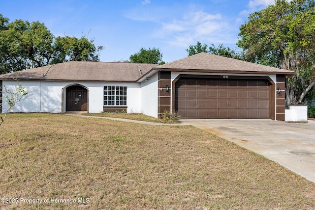 ranch-style home featuring a front lawn and a garage