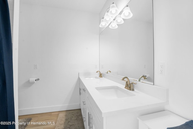 bathroom with hardwood / wood-style floors and vanity