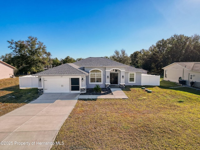 view of front of home featuring a front yard and a garage