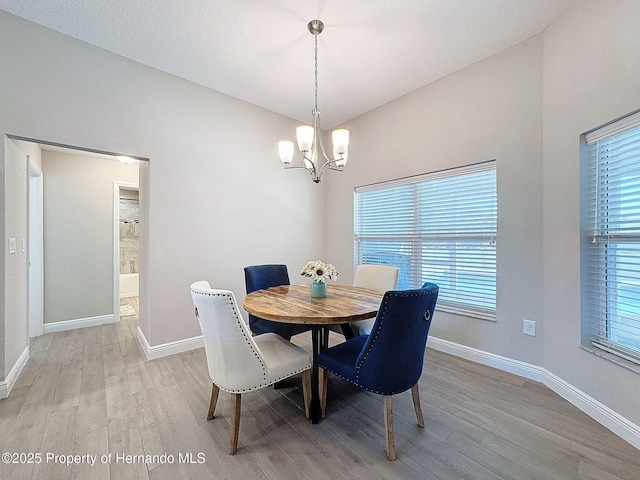 dining room featuring a chandelier and light hardwood / wood-style floors