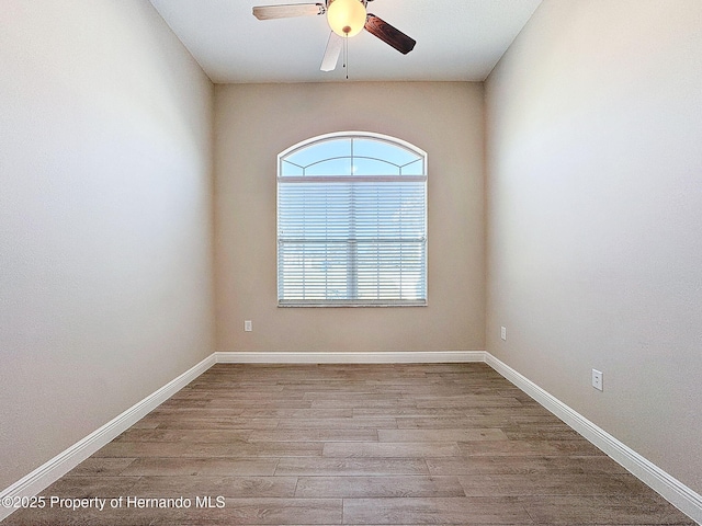 unfurnished room featuring light hardwood / wood-style flooring and ceiling fan