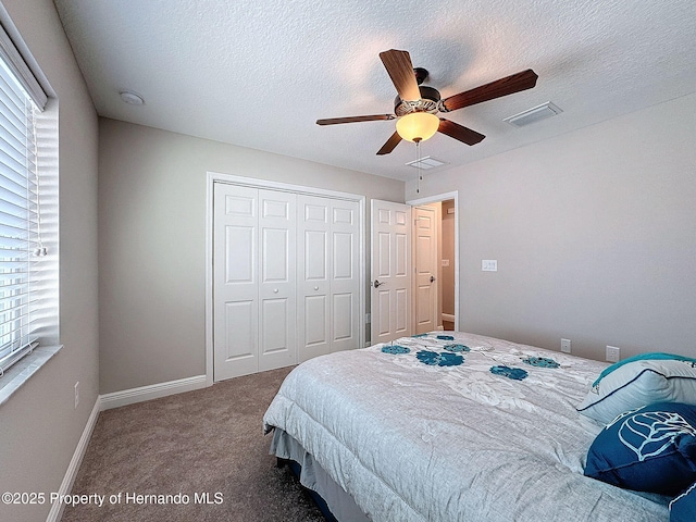 bedroom with ceiling fan, a closet, carpet floors, and a textured ceiling