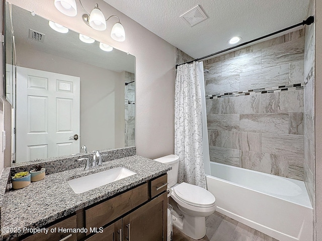 full bathroom with vanity, a textured ceiling, shower / bath combo with shower curtain, wood-type flooring, and toilet