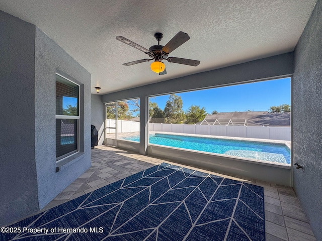 exterior space with ceiling fan and a patio