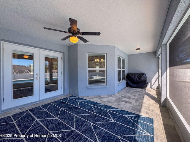 exterior space featuring french doors, grilling area, and ceiling fan