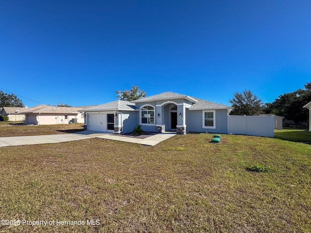 view of front facade with a front yard and a garage