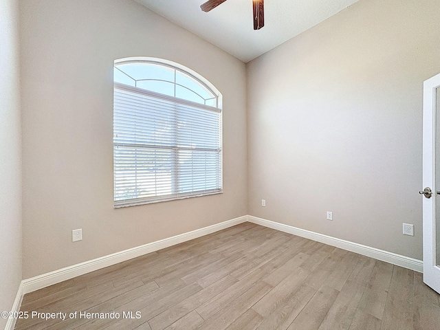 empty room featuring ceiling fan, plenty of natural light, and light hardwood / wood-style floors