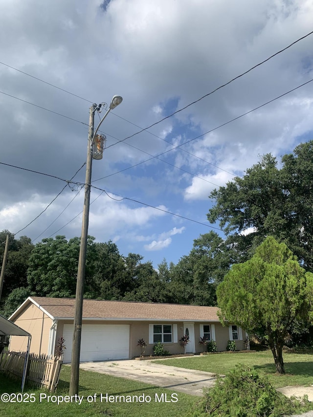 view of front of home with a front yard and a garage