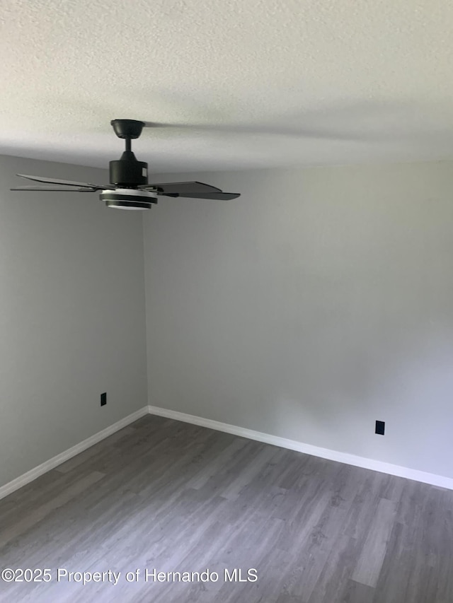 spare room featuring ceiling fan, a textured ceiling, and hardwood / wood-style flooring