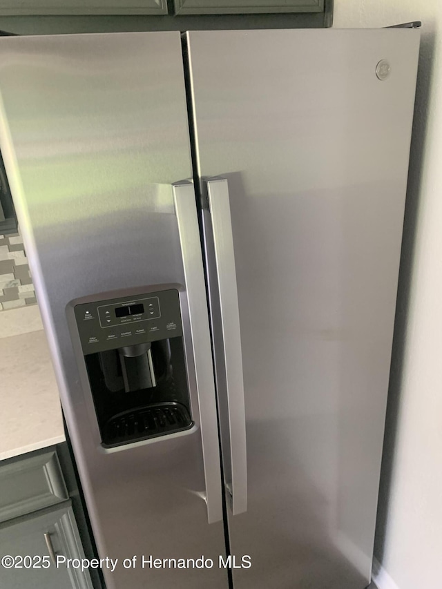 room details with stainless steel fridge and backsplash