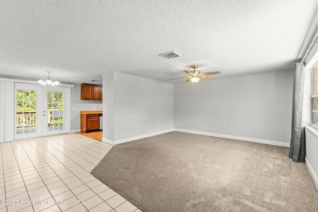 unfurnished living room featuring light carpet, ceiling fan with notable chandelier, and a textured ceiling