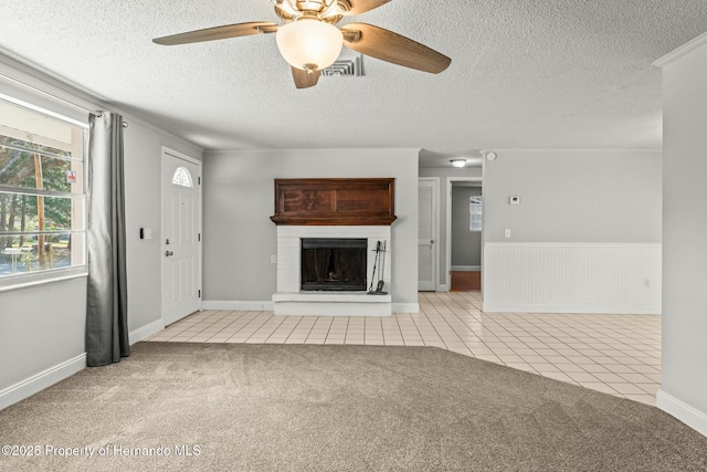 unfurnished living room featuring ceiling fan, light carpet, and a textured ceiling